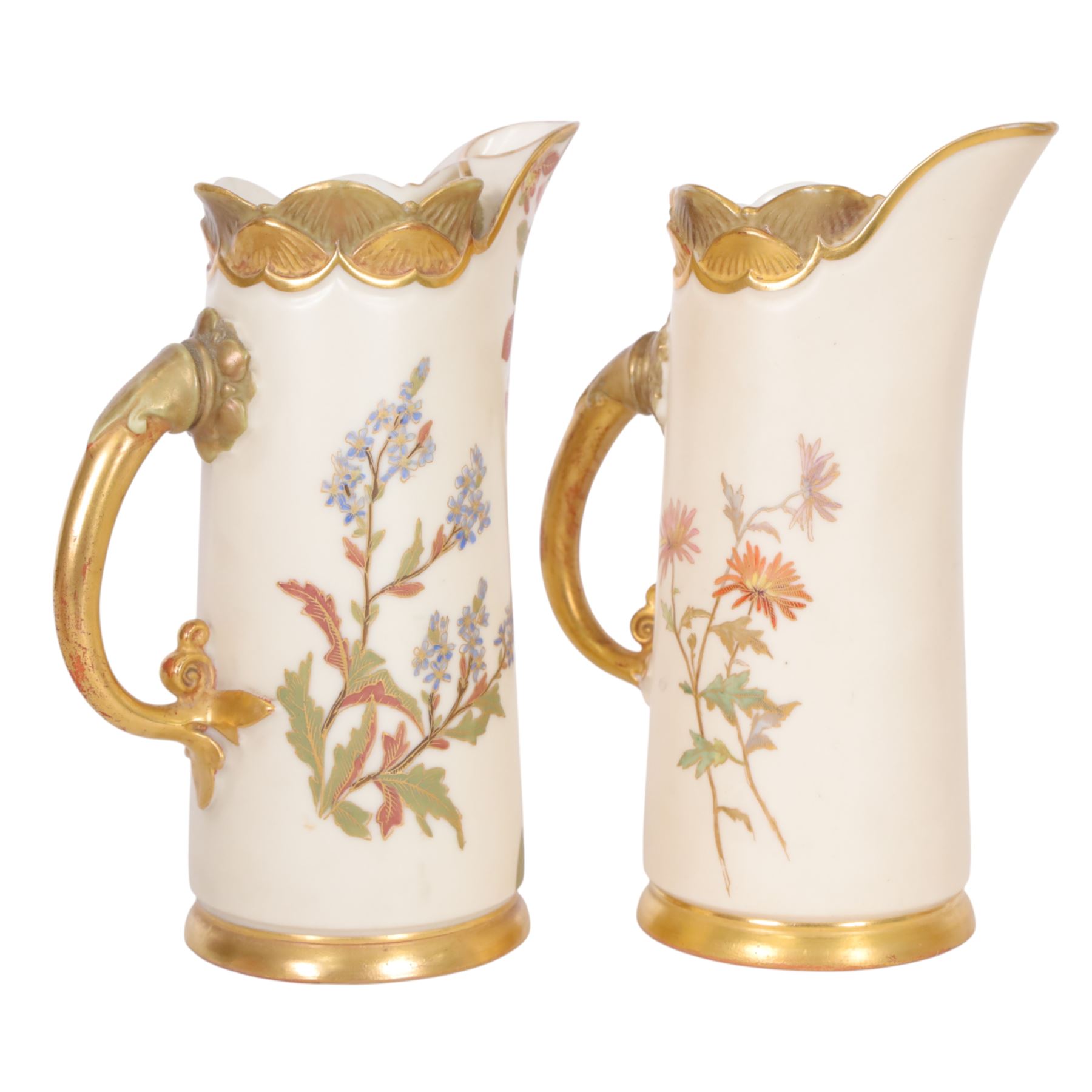 Royal Worcester blush ivory quatrelobe coral jug, decorated with floral sprigs shape 1507 together with two jugs with a shell moulded rim and decorated with flowers, shape 1229, all with puce marks beneath, quatrelobe jug H22cm 
