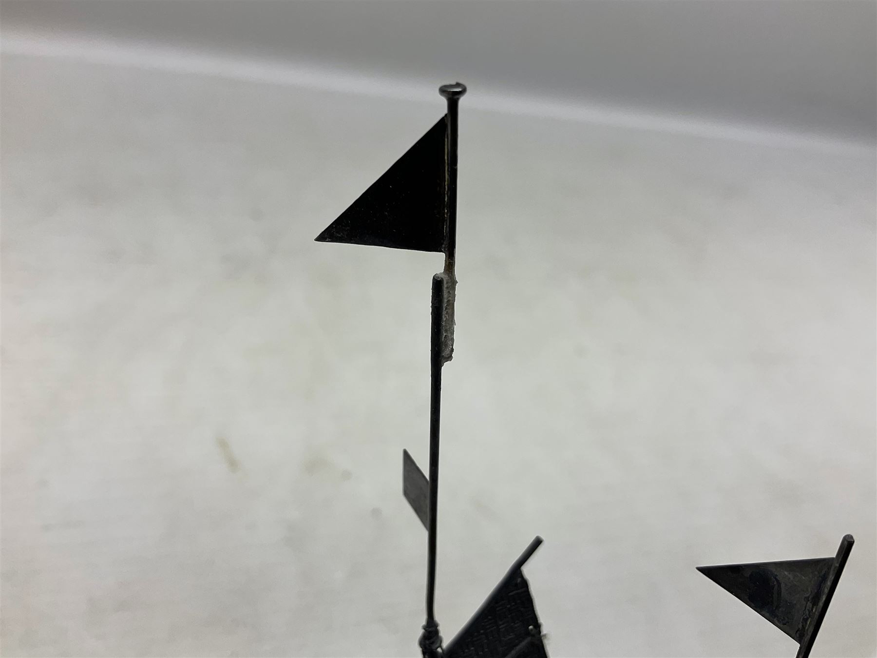 Chinese miniature silver model of a junk ship, with textured sails, mounted upon a carved wooden stand, H14cm