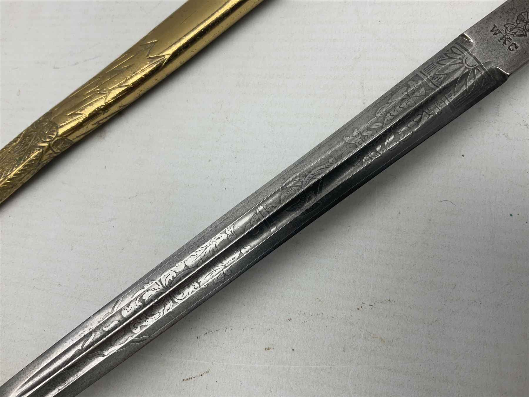 WW2 German kreigsmarine style dagger composed from various age parts, the post-war 25cm double fullered blade  with etched decoration and inscribed WKC with knight's head; in gilt brass scabbard with two rings L42cm overall