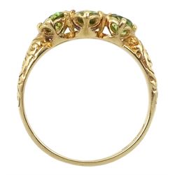 9ct gold three stone peridot ring with scroll design shoulders, hallmarked 