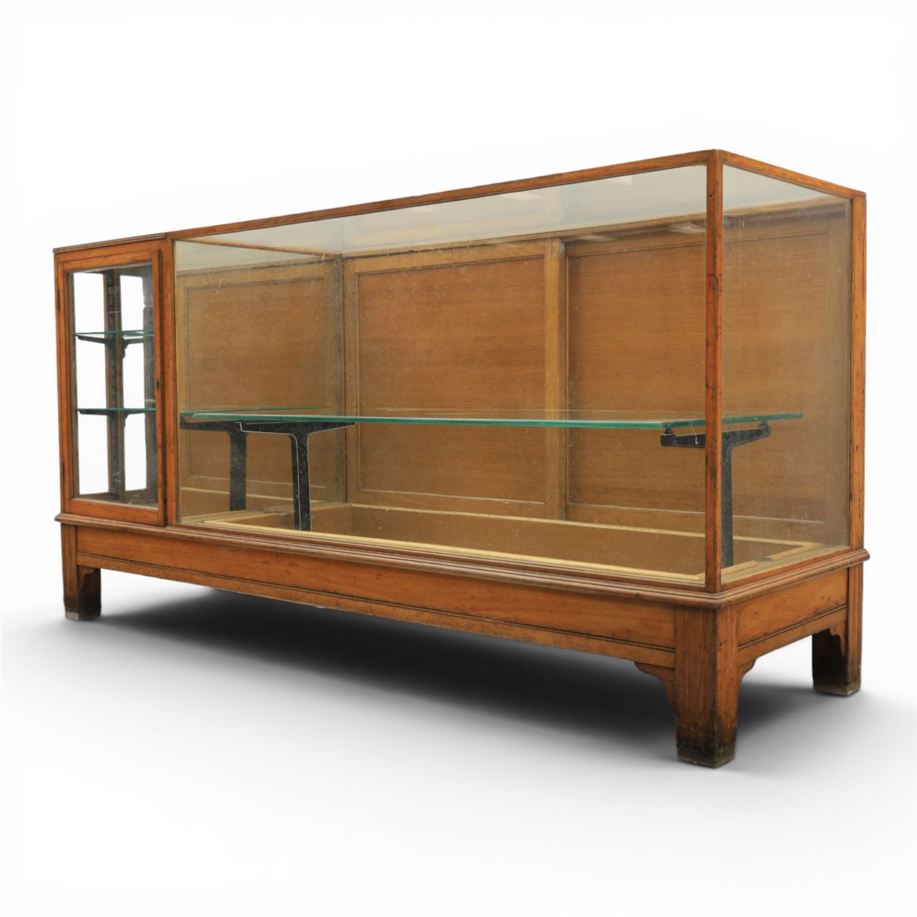 Early 20th century oak framed and glazed haberdashery shop counter with sliding doors and cupboards