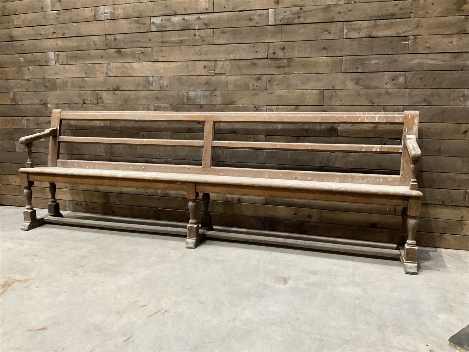 Victorian pitch pine bench pew, turned arms and legs, rail back with plank seat, 274cm