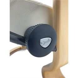 Ekornes - Stressless armchair upholstered in cream leather with matching footstool 