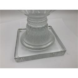 Large and impressive Lalique Versailles pattern glass vase, of classical baluster form with gadrooned flared rim, the body moulded in relief with fruiting vines above part fluting, upon a spreading circular foot with moulded decoration, and plain square plinth base, signed Lalique France to side of plinth, overall H35cm, with original box 