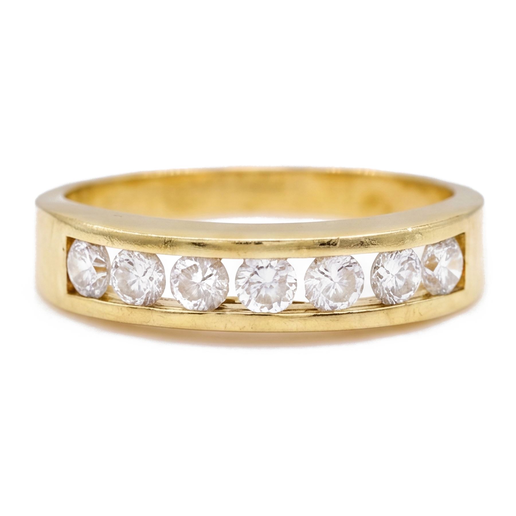 18ct gold diamond ring, channel set with seven round brilliant cut diamonds, hallmarked, total diamond weight 0.75 carat