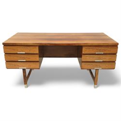 Mid-20th century rosewood pedestal desk, the rectangular top above twin pedestals each fitted with three drawers, all with recessed metal pulls, raised on square legs with stretcher supports and capped metal feet