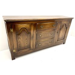 Mid to late century oak dresser base, three graduating drawers flanked by two cupboards, stile supports 