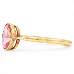 Early 20th century gold padparadscha sapphire ring, milgrain set with a single oval cut sapphire of approx 1.05 carat
