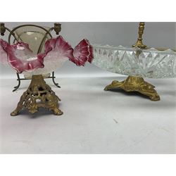 20th century moulded glass and gilt centre piece bowl with carrying handle and ornate trefoil base, together with frilled cranberry edge glass comport with ornate gilt base, and further centre piece with  large glass handle of twisted form, tallest H54cm