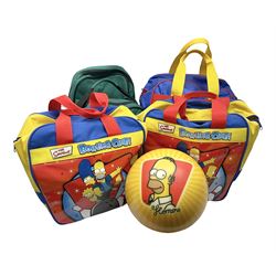 Two The Simpsons 'The Bowling Club' tenpin bowling balls, the first an undrilled example depicting Bart Simpson on a green ground, the second a drilled example depicting the Simpsons family on an orange ground, both in Simpsons The Bowling Club bags, together with a Disney Monsters, Inc. tenpin bowling ball, in matching bag and a Maxim tenpin bowling ball