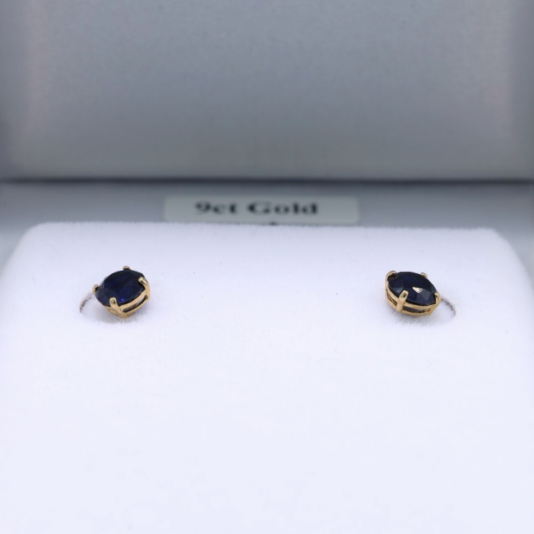 Pair of 9ct gold blue stone stud earrings, boxed