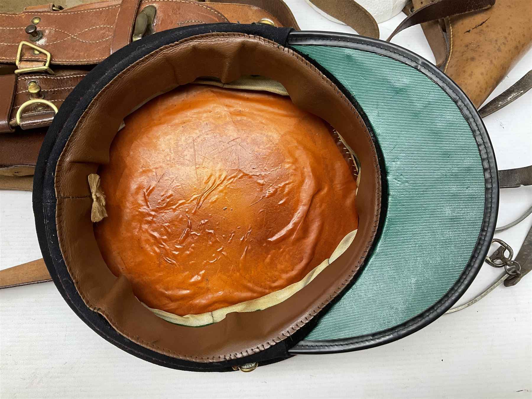British Army General Staff officer's peaked cap by Herbert Johnson London in Moss Bros. delivery box; two officer's Sam Browne leather belts; leather pistol holster and sword hanger; pair of leather gloves and pair of spurs