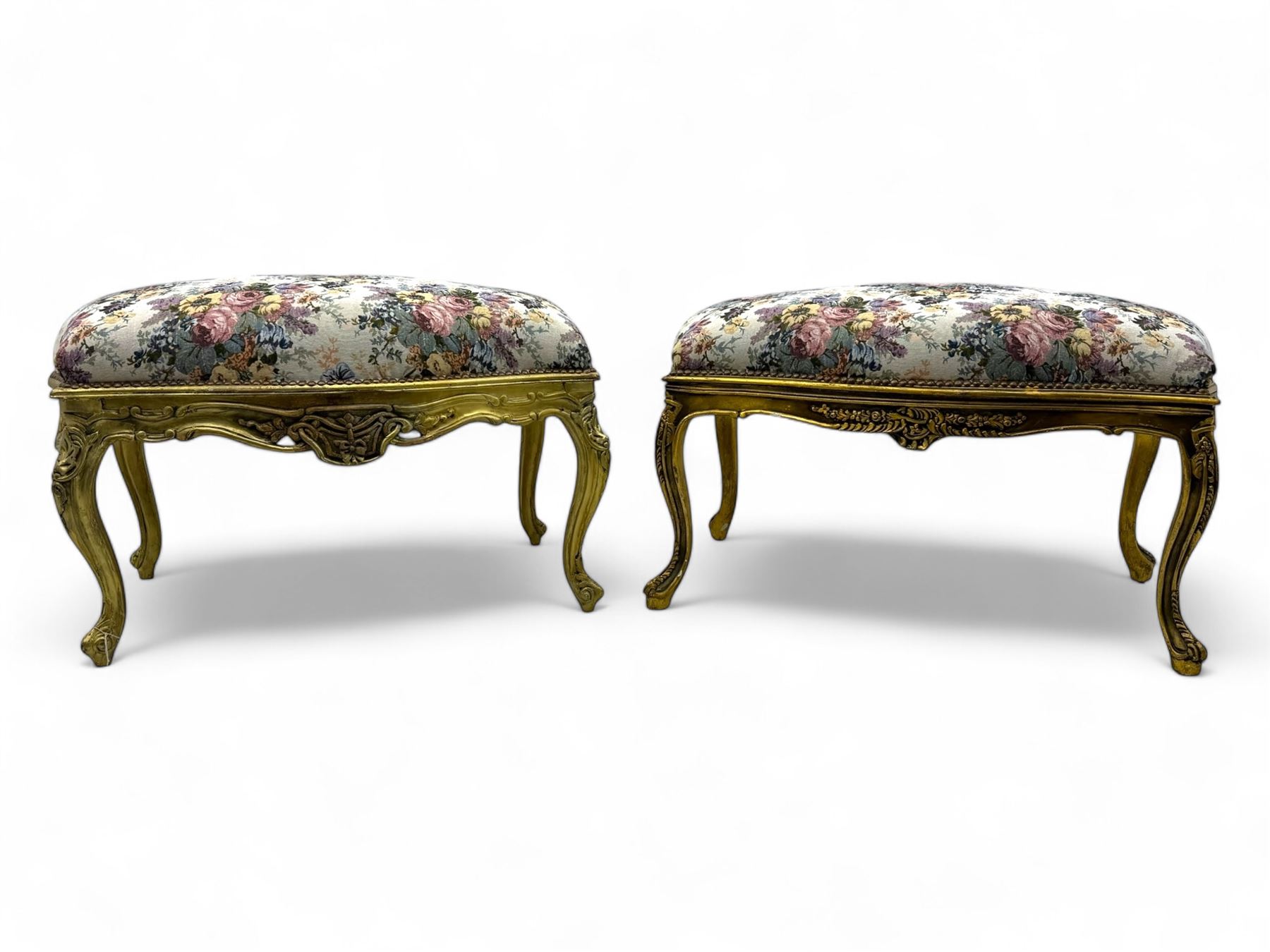 Pair of Louis XV-design giltwood stools, each upholstered in floral tapestry fabric, the carved frame adorned with scrolling foliage and shell motifs, raised on cabriole supports