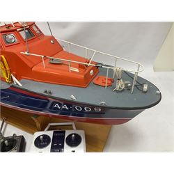 Two remote controlled kit-built plastic model boats - RNLB Sheerness Lifeboat Helen Turnbull L92cm and 'Conserver' Grangemouth L76cm; each on wooden stand; together with three remote control units