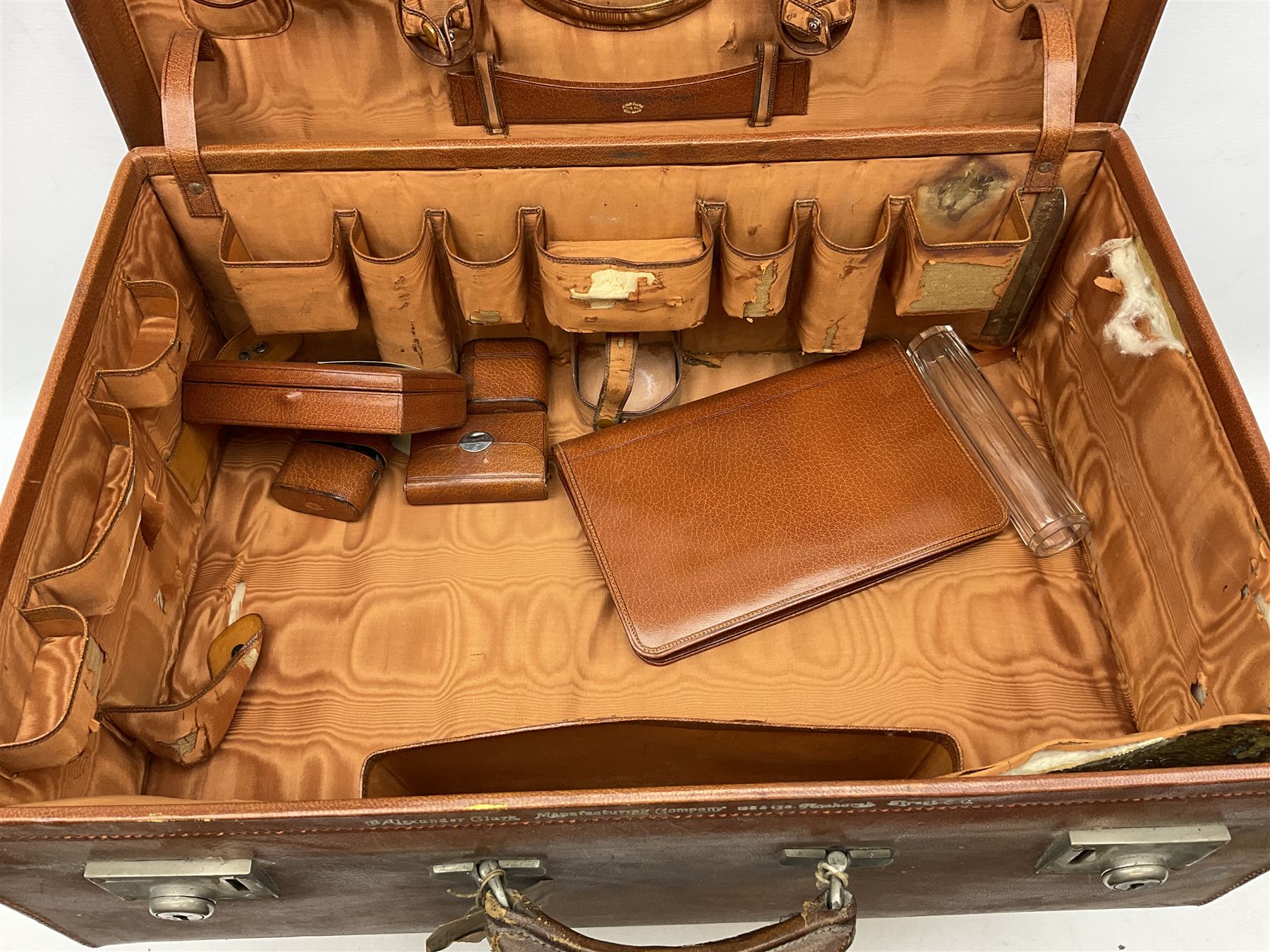 Vintage leather traveling case with monogram to cover, with watered silk lining to interior, and some contents, plus a further vintage travel case, (2)