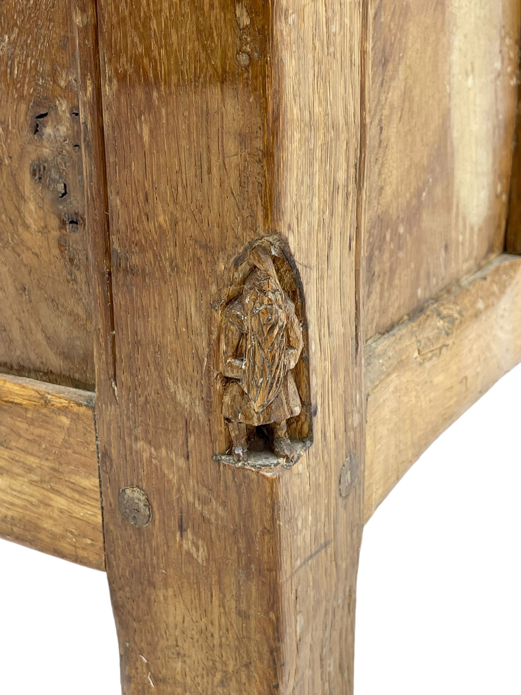 Gnomeman - oak blanket box, all-over adzing, the hinged top over figured and burr panelled front, decorated with carved crenellations and arcade, carved with gnome signature, pierced handles to each end forming the central rail, wrought metal hinges, on stile supports, by Tom Whittaker, Littlebeck, Whitby