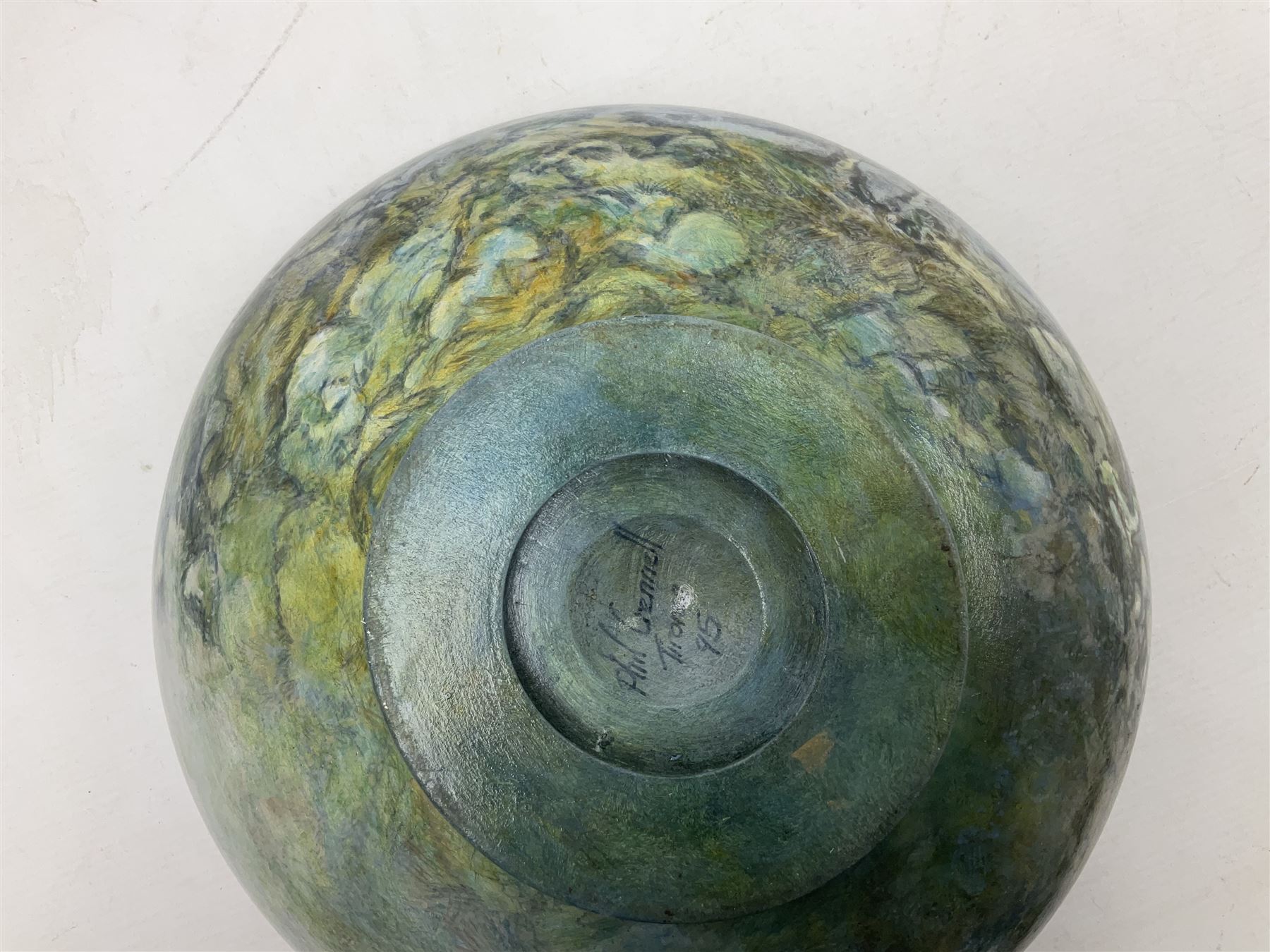 Wooden hand painted bowl, decorated with trees on a blue ground, signed Phil Crennell beneath, D28cm