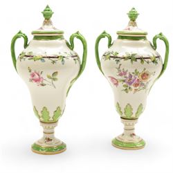 Pair of Dresden lidded vases with twin handles, decorated with flowering sprigs and a foliate boarder, H25cm