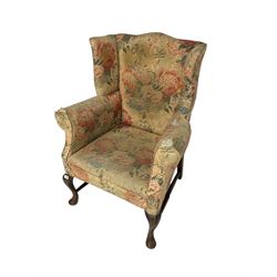 Early 20th century Georgian style wingback armchair, upholstered in floral fabric with sprung seat, walnut frame with front cabriole supports