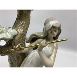 Lladro figure, Musical Muse, modelled as a woman playing a flute under a tree, sculpted by Antonio Ramos, with original box, no 5651, year issued 1990, year retired 1996, H34cm