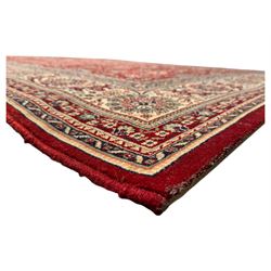 Royal Kashmir worsted wool modern Persian design area rug, with crimson field and stylised rosette patterning throughout, surrounded by wide multi-band border incorporating cartouche and lotus flower motifs