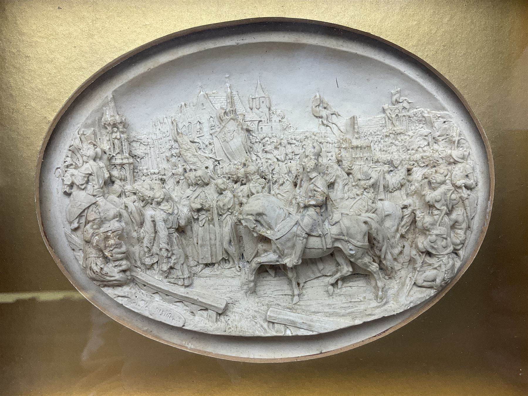 Justin Mathieu, two oval high relief plaque depicting a battle scenes, each within a wooden frame, frame  H21cm, L25cm