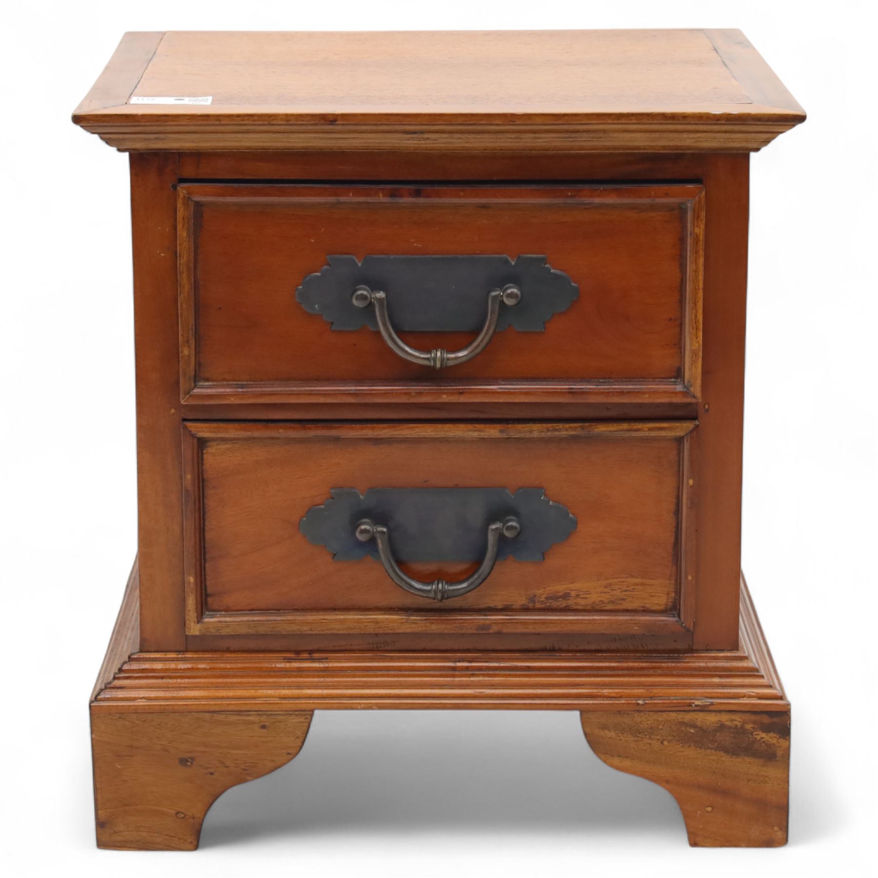 Singapore hardwood bedside chest, rectangular moulded top above two drawers fitted with metal plate handles, on shaped bracket feet