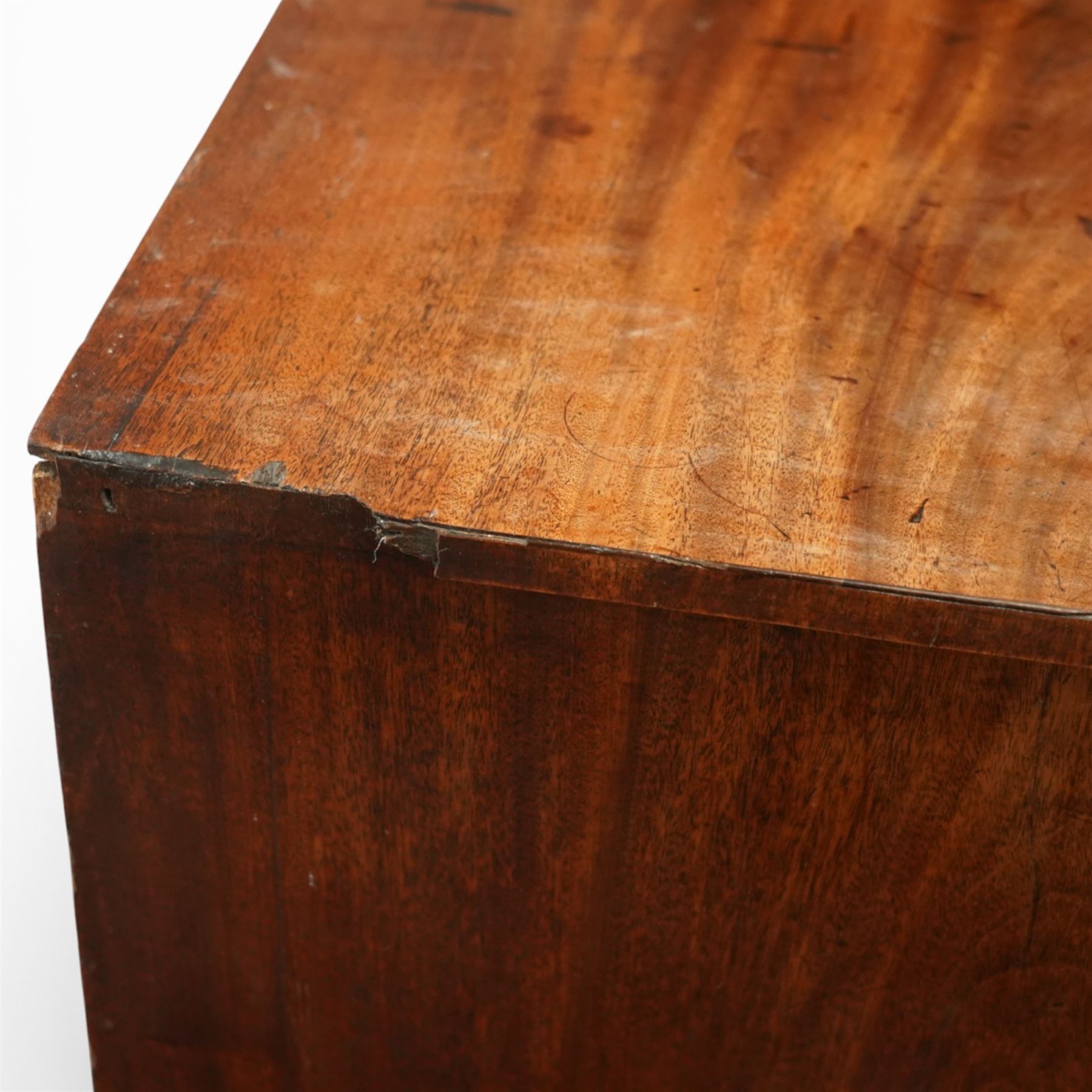 Small 19th century mahogany chest of drawers, rectangular top with moulded edge over three short and two long drawers, the drawers fitted with brass ring handles and key escutcheons, raised on shaped bracket feet