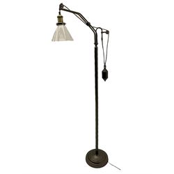 Industrial floor lamp in matte bronze finish with adjustable cantilever head