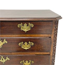 George III Chippendale design mahogany chest, moulded rectangular top with canted corners, wide canted uprights with blind fretwork decoration, two short and three long with moulded fronts, shaped brass handle plates, on ogee bracket feet 