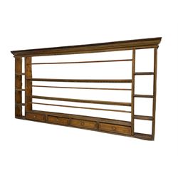 18th century pine wall hanging plate rack, projecting cornice over three tiers and four spice drawers, flanked by four tier shelves