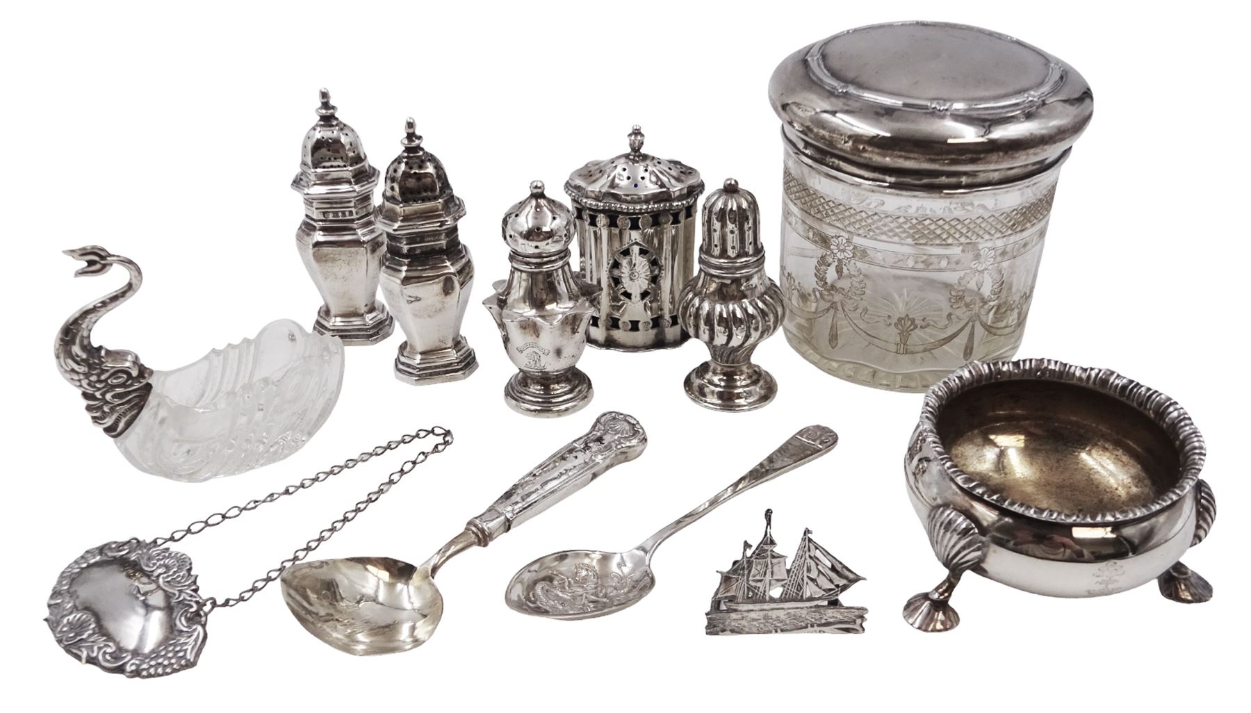 Group of silver, to include Edwardian silver open salt, of circular bellied form, with gadrooned rim, upon three shell feet, hallmarked Mappin & Webb Ltd, London 1906, together with a blank decanter label, repousse decorated with fruiting vines, hallmarked W I Broadway & Co, Birmingham 1995 and five silver pepper shakers, all hallmarked with various dates and makers, etc 