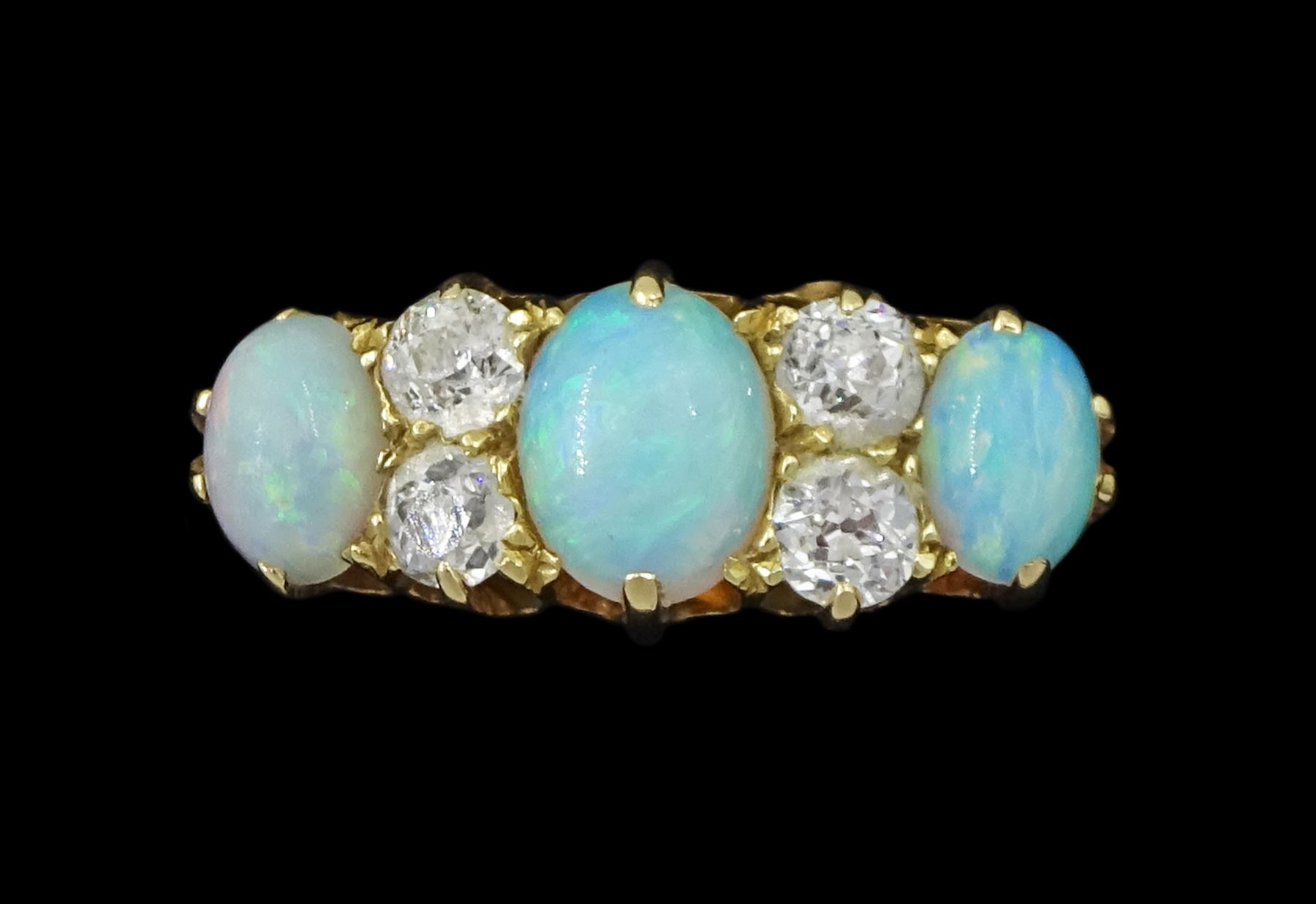 Early 20th century 18ct gold three stone opal, the centre stone set with two old cut diamonds either side, London 1913, total diamond weight approx 0.30 carat