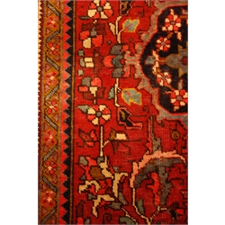  Persian Hamadan red ground rug carpet, with large central medallion on floral field, repeating guarded border, 375cm x 275cm  