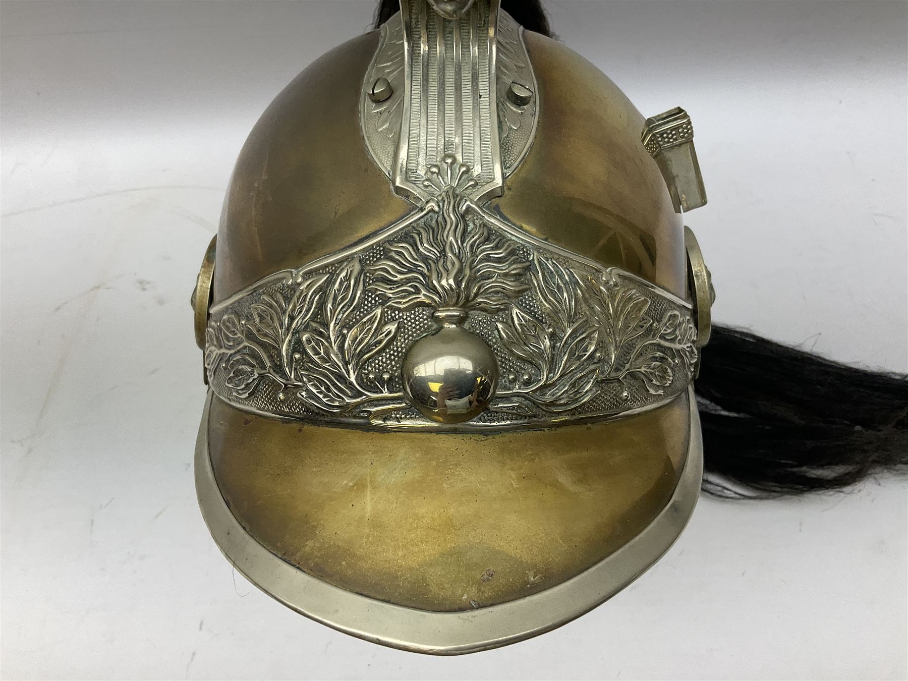 French Model 1913 mounted gendarmerie helmet; brass bodied with nickel mounts, chin strap, comb and horse-hair H27cm (no liner)