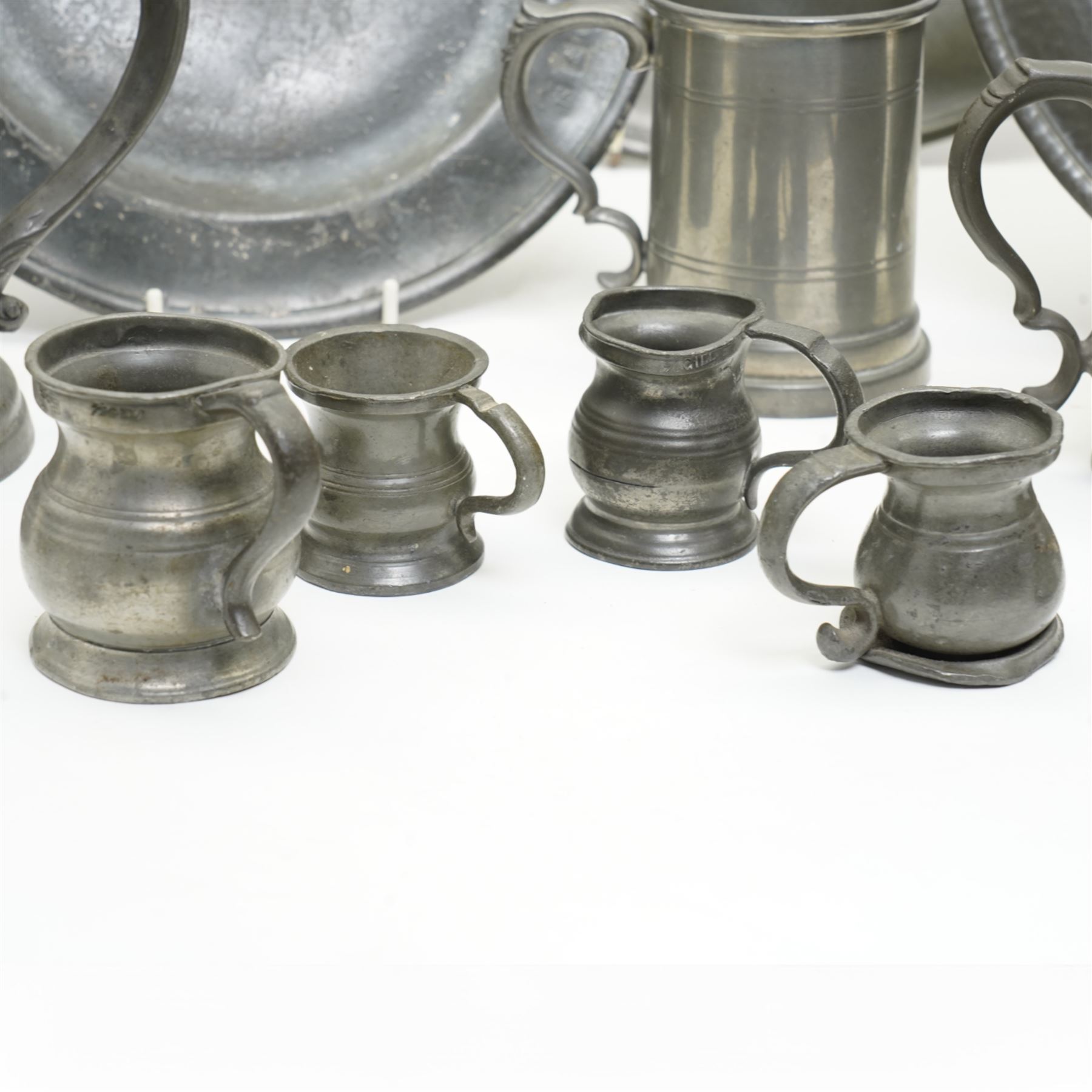 Collection of early 19th century and later British pewter, including a Palliser's of Wolverhampton 1/4 Gill measure and other measures, Skell & Chambers of Birmingham jug, etc