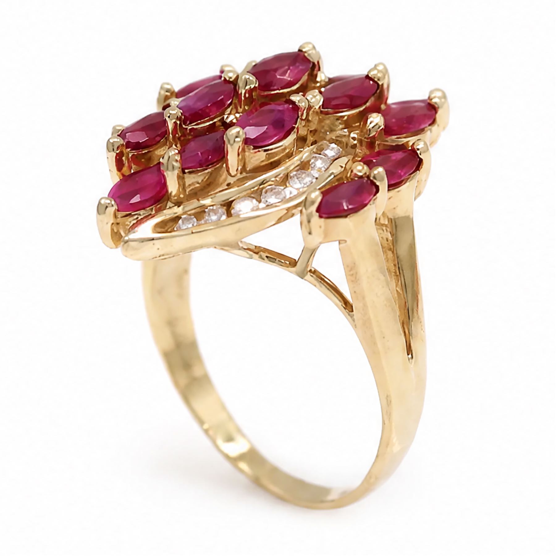14ct gold ruby and diamond cluster ring, set with fifteen marquise cut rubies and fourteen channel set round brilliant cut diamonds, stamped 585