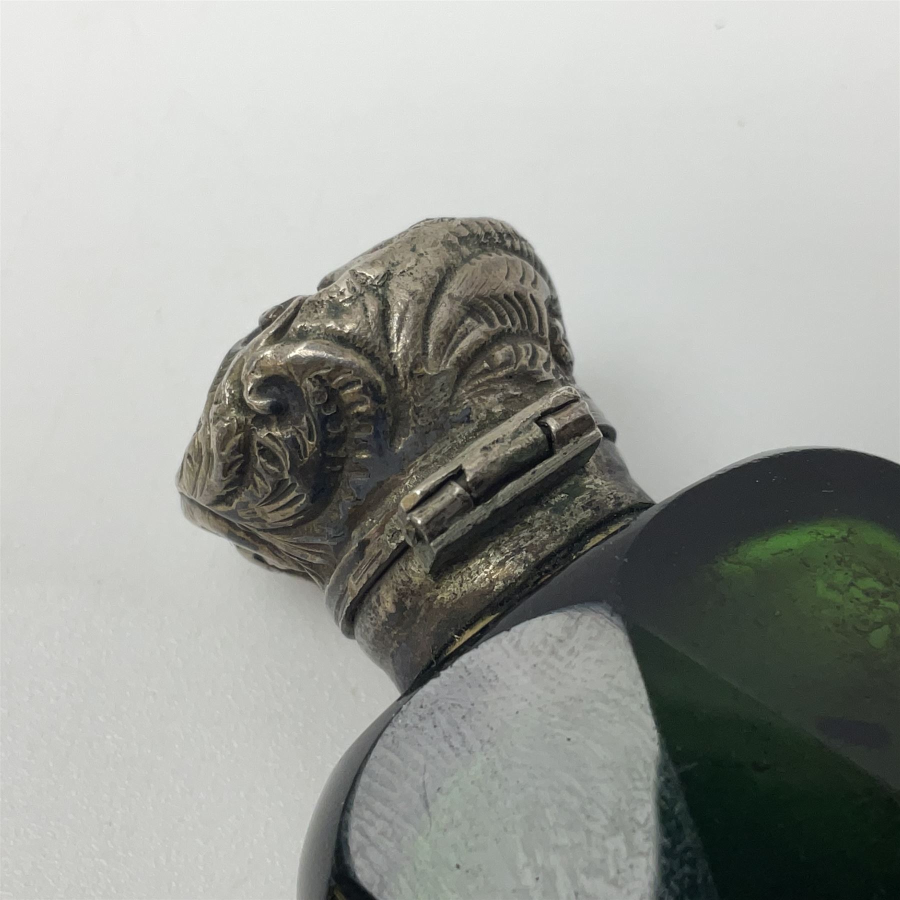 Silver mounted green glass scent bottle, with original stopper, and embossed silver cover, H7cm