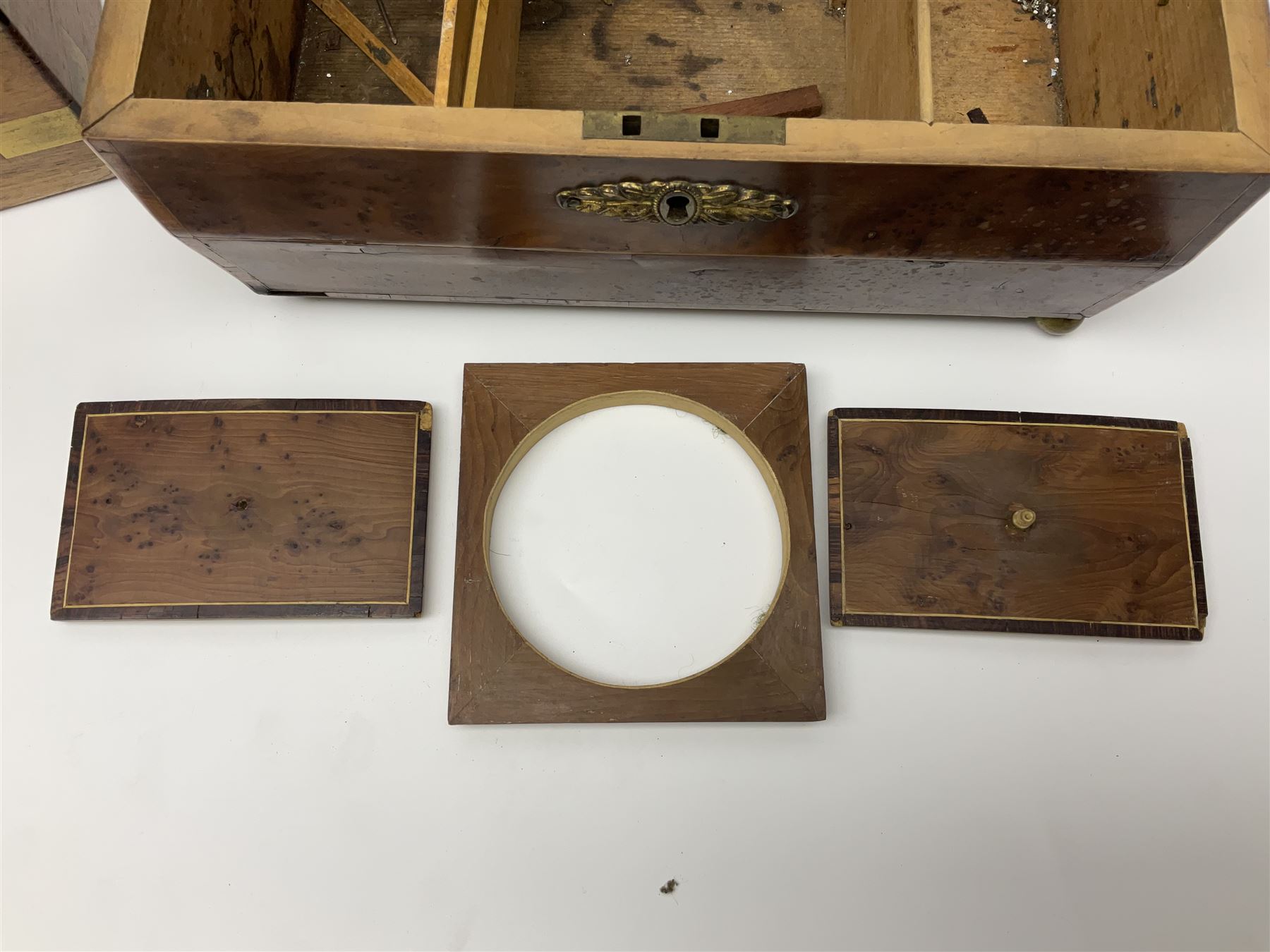 19th century burr yew wood tea caddy, of sarcophagus form, with strung details and brass mounts, the interior split into three compartments, upon four brass bun feet, together with an oak and brass bound writing slope, with red leather interior with gilt detailing, largest H16cm, W40cm