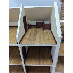 1:24 scale stone effect three-storey cottage dolls house, with green arched door and lattice effect windows, decorated to the interior with wooden floors, wired lighting and fire places, H45cm, W57cm, D26cm