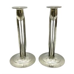 Archibald Knox (1864-1933) for Liberty & Co, pair of Tudric pewter candlesticks, the bud shaped sockets raised upon three angular fin supports and a slightly domed circular base with cast stylised foliate decoration, each stamped beneath Tudric 0223, H30cm