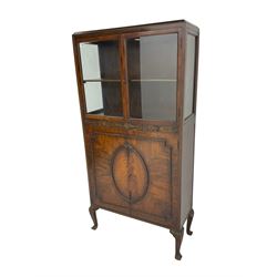 Mid-20th century mahogany display cabinet, two glazed doors above rail carved with flower heads, two figures doors below with applied flower head oval garland and geometric mouldings, on acanthus carved cabriole supports 