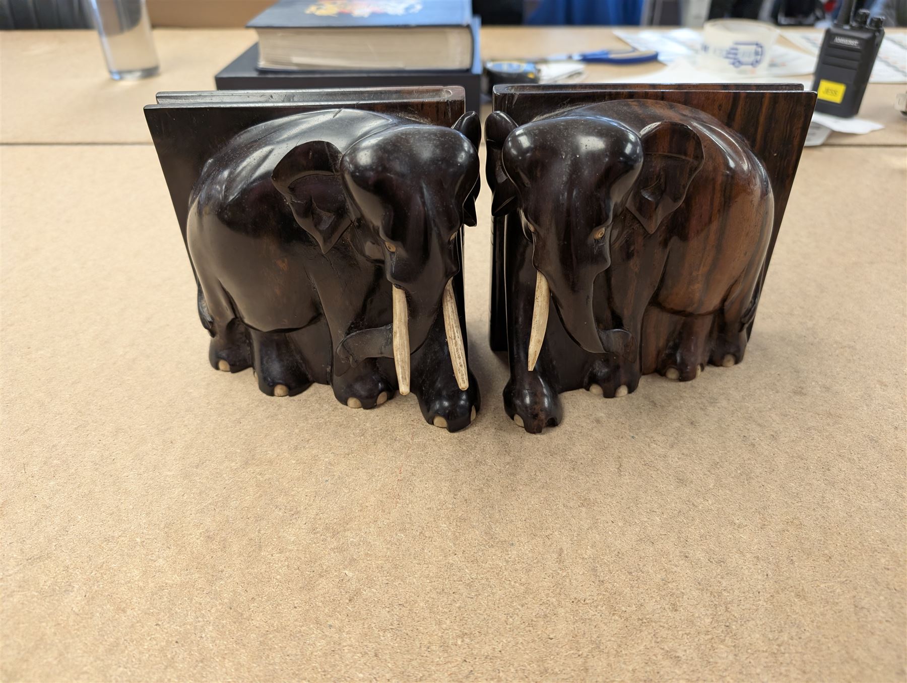 Pair of carved elephant bookends with bone tusks, H14.5cm