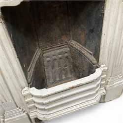 Two Victorian small cast iron fireplaces in a white finish