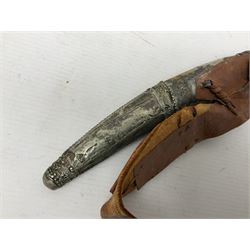 Saudi Arabian khanjar dagger with 29.5cm curving double edged  steel blade; white metal and copper mounted horn grip; in white metal mounted brass and leather scabbard incorporating embroidered leather wearing strap
