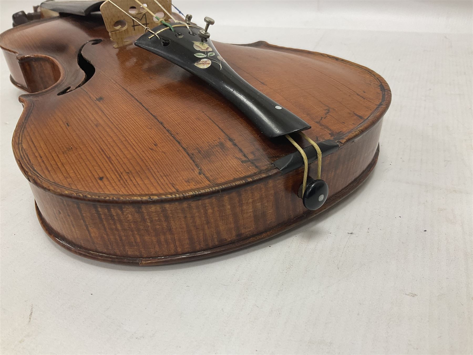 19th century full sized violin in a later hard case, decorative mother of pearl inlay to the tail piece Overall length 60cm No bow
