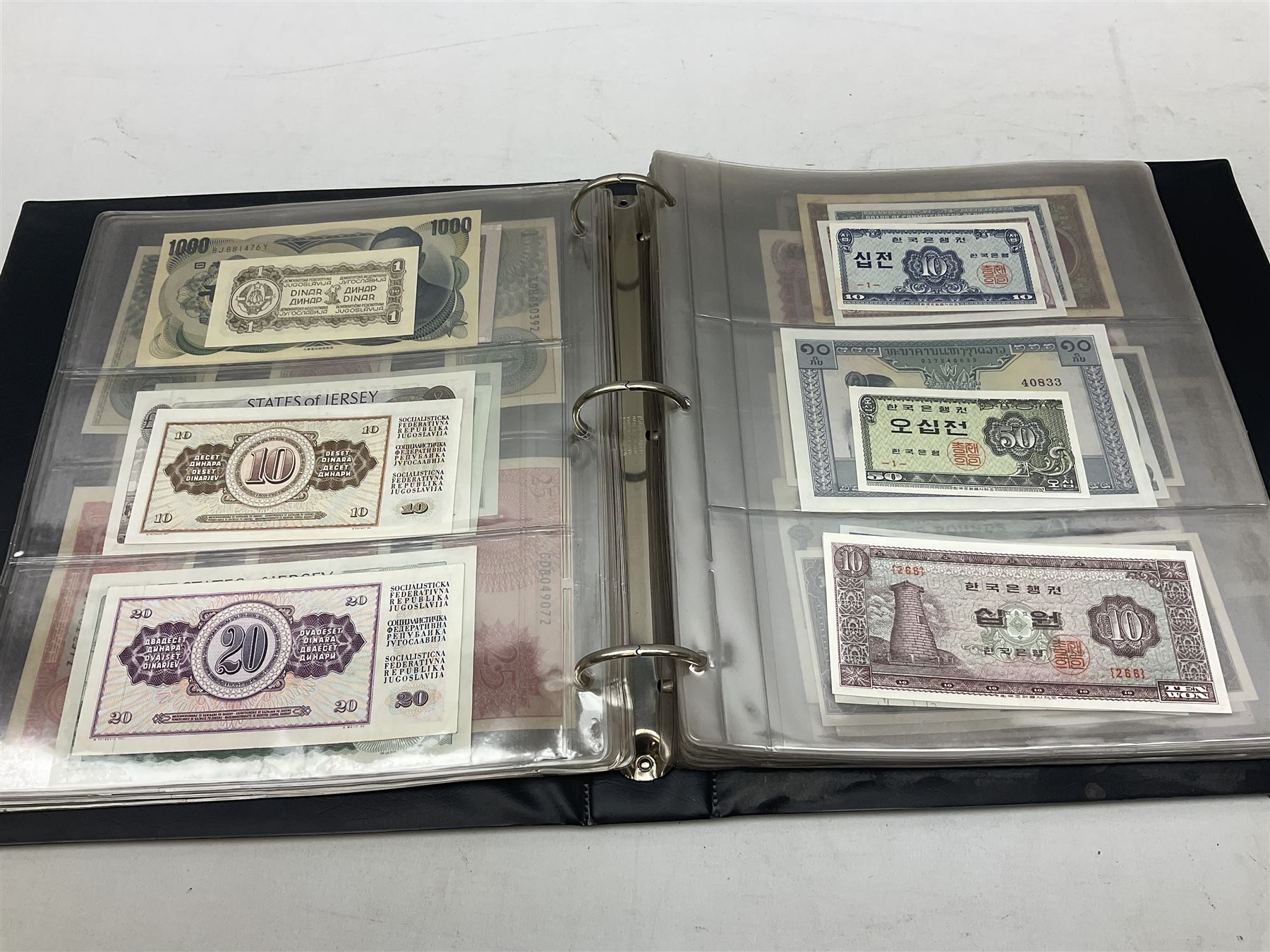 World banknotes, including Queen Elizabeth II The States of Jersey one pound 'DB202703', five pounds 'BB527762' and ten pounds 'AB651481', reserve bank of New Zealand two dollars '1L3 741894', King George V Straits Settlements one dollar 1st January 1935 'F/83 28924', various Bank of England notes etc, housed in two ring binder albums