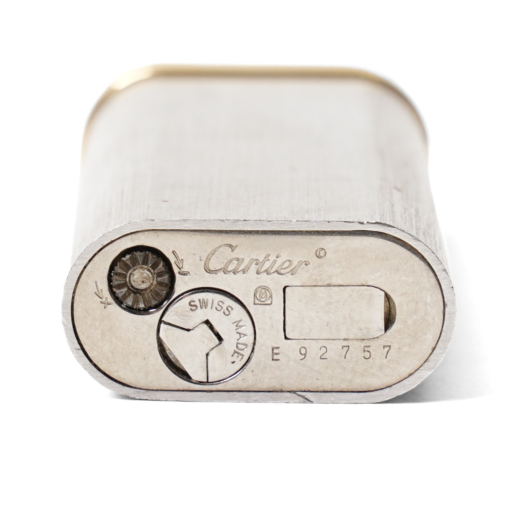 Cartier - silver-tone and gold-tone pocket lighter, with brushed vertical finish, hinged cover and gold-tone band signed Cartier, base signed Cartier and numbered, with original fitted presentation box, outer box and international guarantee booklet