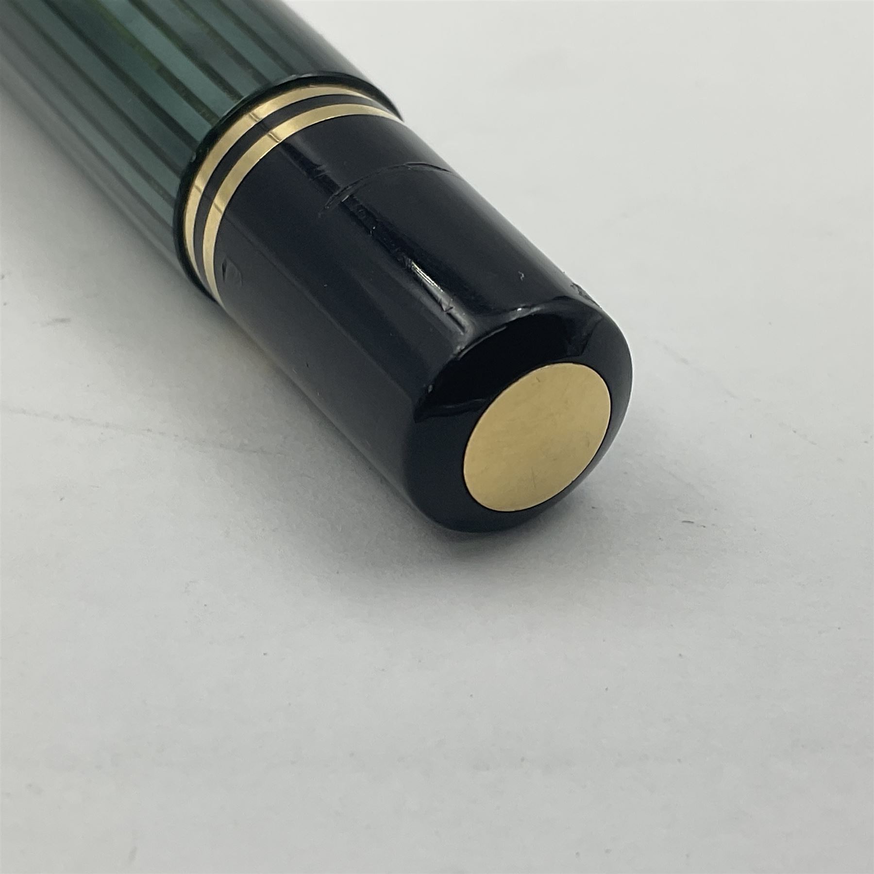 Pelikan M800 Souveran fountain pen, the green and black striped barrel with gilt beak shaped clip and double cap band with gold bi-colour nib stamped 18C-750, L13.5cm