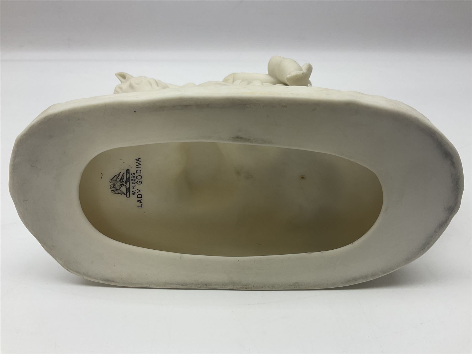 W.H.Goss Parian figure of Lady Godiva, with printed mark beneath, together with a W.H.Goss crested ware Rivaulx Abbey tumbler, and three similar Waterfall Heraldic China crested ware items, Godiva H19cm 